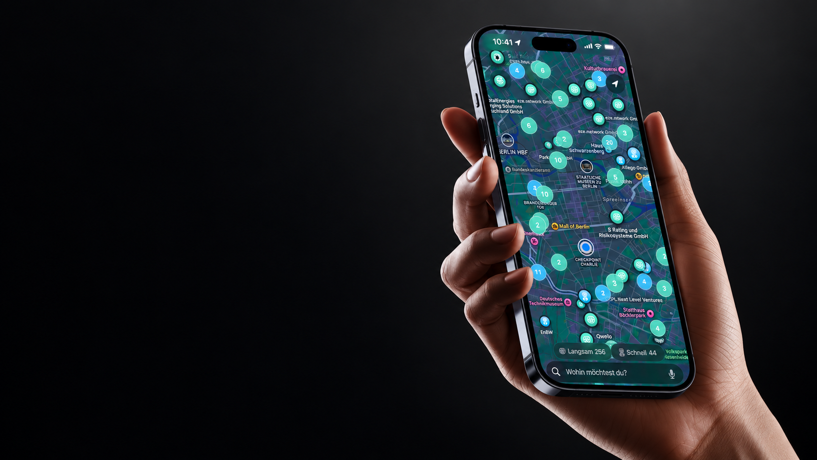Illustrative Aura mockup of a hand holding an iPhone with the Charge a Smile charging map composited onto its screen
